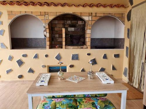 a room with a table and a stone wall at Finca Maradentro - private pool and jacuzzi with ocean view in Arafo