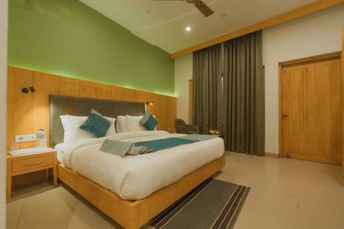 a bedroom with a large bed in a room at Excel Hotels and Resorts Bhimtal in Bhīm Tāl