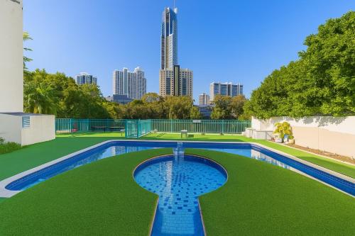 a swimming pool with a city skyline in the background at Surfers Paradise Center- Ocean View Vacation Condo-Pool&Pier,Walk to Beach in Gold Coast