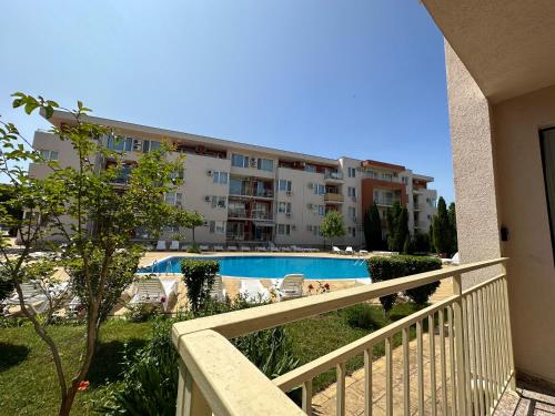 a balcony of a building with a swimming pool at The Sunny Spot in Sunny Beach