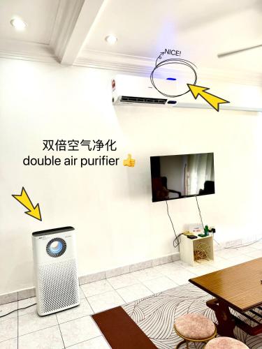 an air purifier in a room with a table at Double Storey 4 room - Walk to Jonker Street #9pax in Melaka