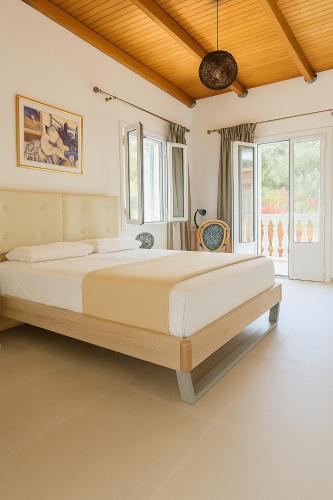 a bedroom with a large bed in a room at Koukou Stay in Vathi