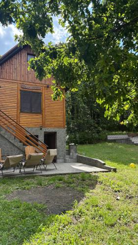a group of chairs sitting in front of a building at Vila Vera in Vršac
