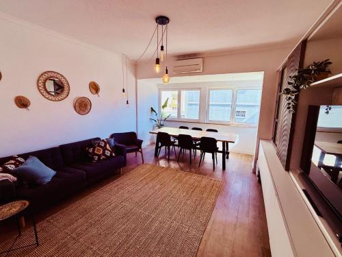 a living room with a couch and a table at NEW 3 Bedroom Beachfront Apartment in Carcavelos