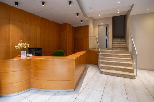 a lobby with a staircase in a building at Hotel Villa de Verín in Verín