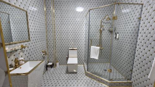 a bathroom with a shower and a sink at Hotel Madonna SPA in Kaskelen