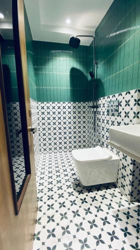 a bathroom with a sink and a toilet in it at Palm Breeze Hotel - Colaba in Mumbai