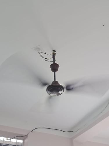 a ceiling fan with a light on a white ceiling at Hotel Chaupari in Bākhri Kharka