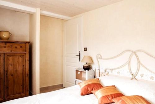 une chambre avec un lit blanc avec deux oreillers dans l'établissement Le Mas des Oliviers, à Redortiers