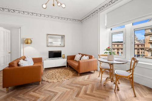 a living room with two chairs and a table at Exceptional Central 1BR Apt - town square views in Oban