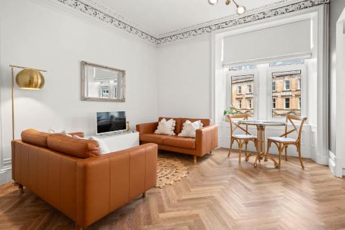 a living room with a couch and a table at Exceptional Central 1BR Apt - town square views in Oban