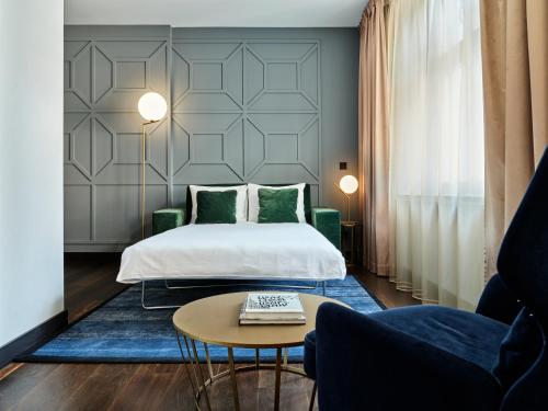 a hotel room with a bed and a table at Hotel Indigo Warsaw Nowy Świat by IHG in Warsaw