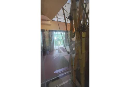 a view of a room with a glass wall at Holiday Courtyard Wayanad in Padinjarathara