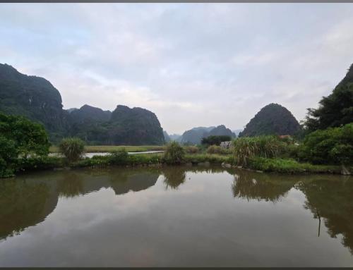 a view of a river with mountains in the background at Hang Mua Luxury Homestay in Xuân Sơn