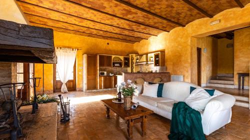 a living room with a white couch and a table at Il Poderuccio 17, Emma Villas in Cetona
