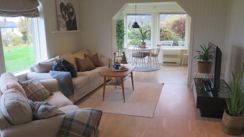 a living room with a couch and a table at Stavetunet in Stadlandet