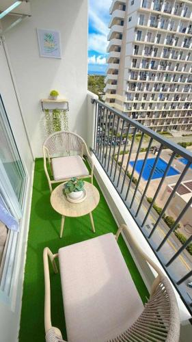 a balcony with two chairs and a table and a table at The Horizons Place in Lapu Lapu City