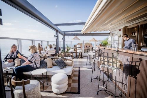 a view of the patio of a restaurant with people sitting at No 42 by GuestHouse, Margate in Margate