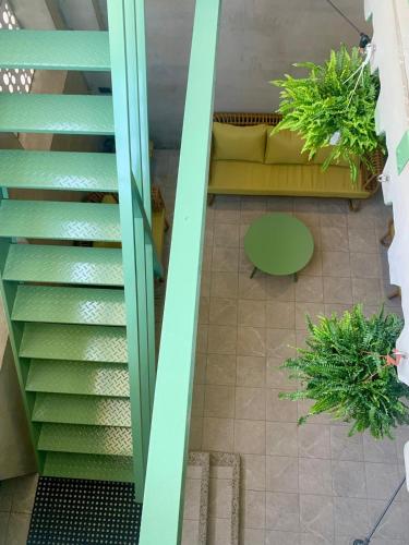 an overhead view of a living room with a couch and stairs at The Moment Hostel Dulan in Donghe