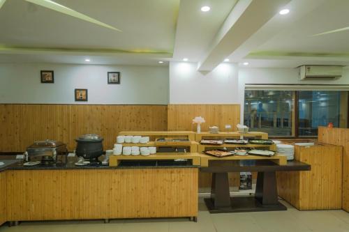 a kitchen with a table with food on it at Excel Hotels and Resorts Bhimtal in Bhīm Tāl