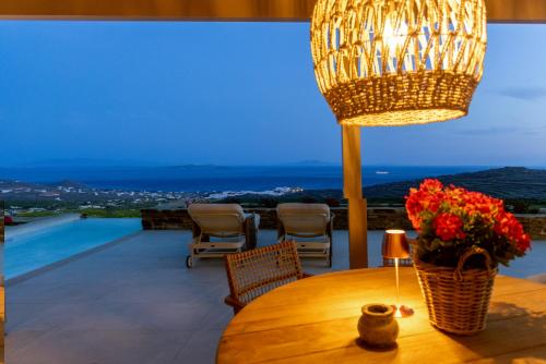 a room with a table with a lamp and a view at Soborgo Exquisite Villas in Tinos Town