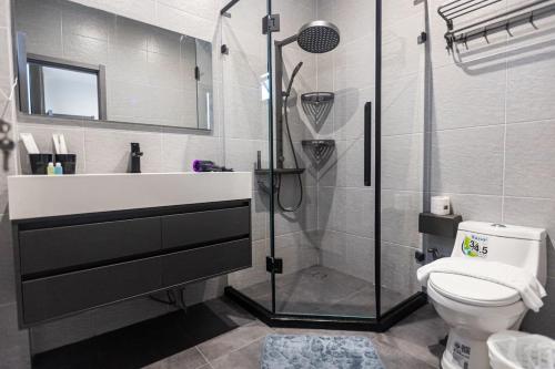 a bathroom with a shower and a toilet and a sink at Sun Sky Pool Villa 5 Bed Group Friendly BBQ KTV in Pattaya South