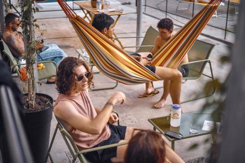a group of people sitting in chairs in a hammock at Ostello Bello Palermo in Palermo
