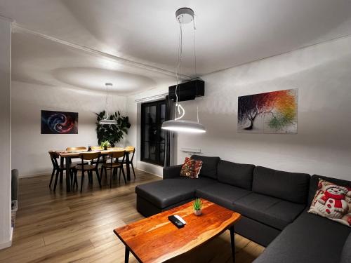 a living room with a couch and a table at Cozy Holeby House Close to Puttgarden & Femern & Lalandia & Knuthenborg in Holeby