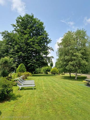 a park with benches sitting in the grass at L'Oasi Amena in Ameno