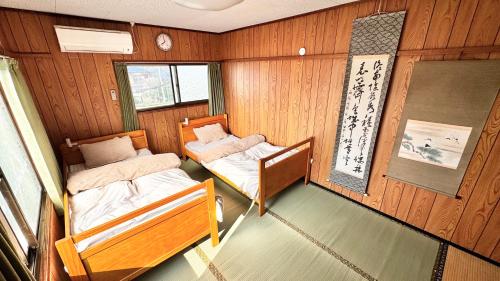 a small room with two beds in a boat at AKARIYA Hostel in Karatsu