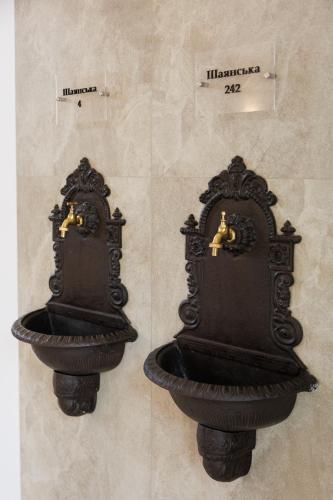 a black object with a sink on a wall at Апартаменти в центрі Шаян in Shaian