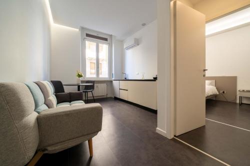 a living room with a couch and a table at La Casa del Bersagliere - STUDIO in Biella