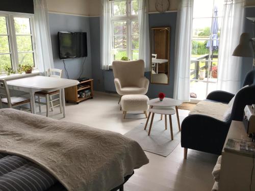 a bedroom with a bed and a table and chairs at Skovgården in Hillerød