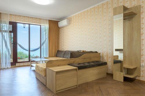 a bedroom with a large bed and a large window at Morski Briag Hotel in Golden Sands