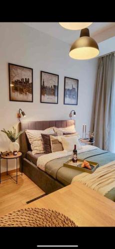 a bedroom with two beds and a table in it at Apartament Nad Starą Odrą in Wrocław