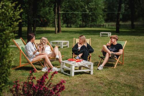 a group of people sitting in chairs on the grass at Hotel Młyn Aqua Spa in Elblag
