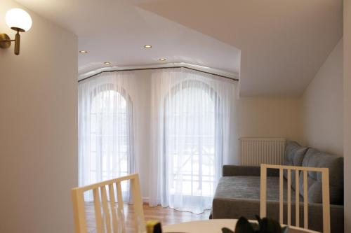 a living room with two windows and a couch at Апартаменти в центрі Шаян in Shaian