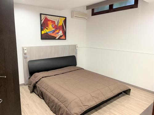 una camera da letto con un letto e un dipinto sul muro di Villa Filó , Vila Sol with pool a Quarteira