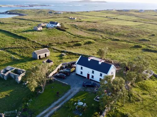 an aerial view of a white house in a field at Nead na bhFáinleog Swallows Nest in Aughrus More