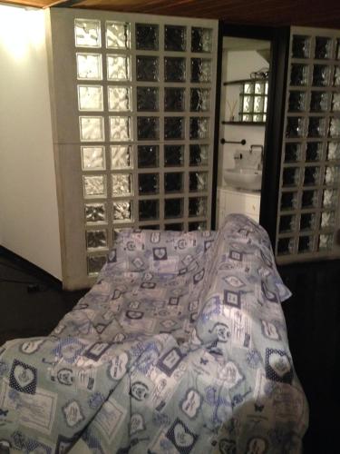 a bed with a blanket on it in a wine cellar at Romeo and Juliet Apartaments in Bergamo