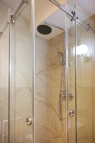 a shower stall with a glass door in a bathroom at Апартаменти в центрі Шаян in Shaian