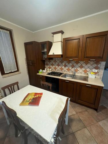 a kitchen with a table and a stove top oven at Casa Lupoli in Cellole