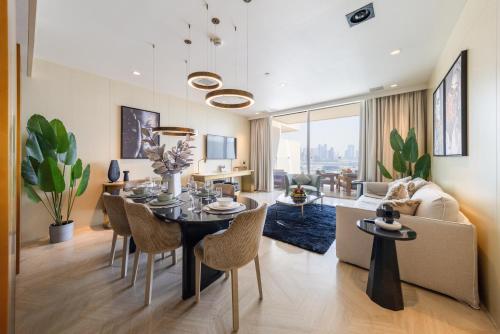 a dining room and living room with a table and chairs at EDEN'S Homes & Villas - FIVE Palm Residences in Dubai