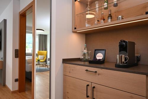 a kitchen with a counter with a coffee maker on it at Best Western Plus Hotel Alpenhof in Oberstdorf