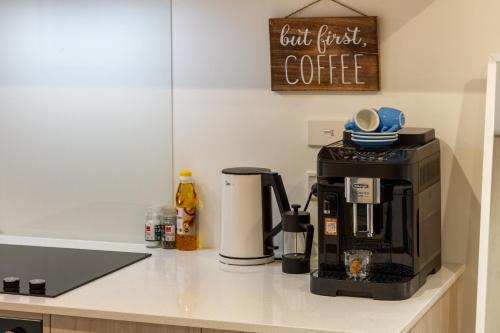 a coffee maker on a counter in a kitchen at Bright & New Studio Unit Walk to Town in Christchurch