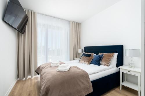 Postel nebo postele na pokoji v ubytování Apartment Opal 21 widok na morze w Balticus Promenada Gwiazd