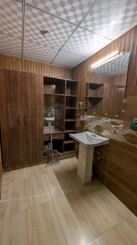 a bathroom with a sink and a bed at The Jade Palace, Hunza in Karimabad Hunza