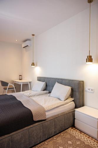 a bedroom with a bed and a table at Апартаменти в центрі Шаян in Shaian