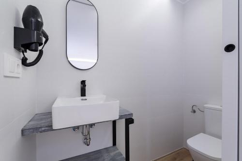 a bathroom with a white sink and a mirror at Casa Castell Orangecosta in Peñíscola