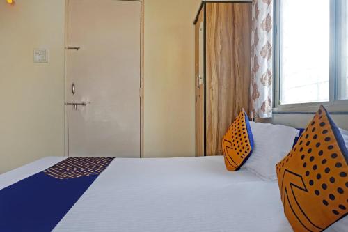 a bedroom with a bed with two pillows on it at Hotel O Chalukya Executive in Phūrsungi